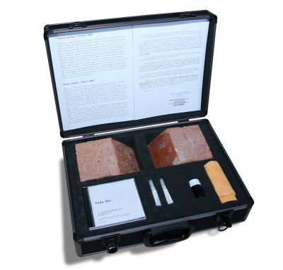 Institutionalized Art, multiple; suitcase contains a brick cut into 2 parts, video, instruction text, special glue, cloths for cleaning glass; mixed media, 2005